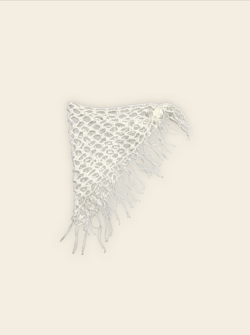 White knitted swim suit wrap with fringe on a light beige background