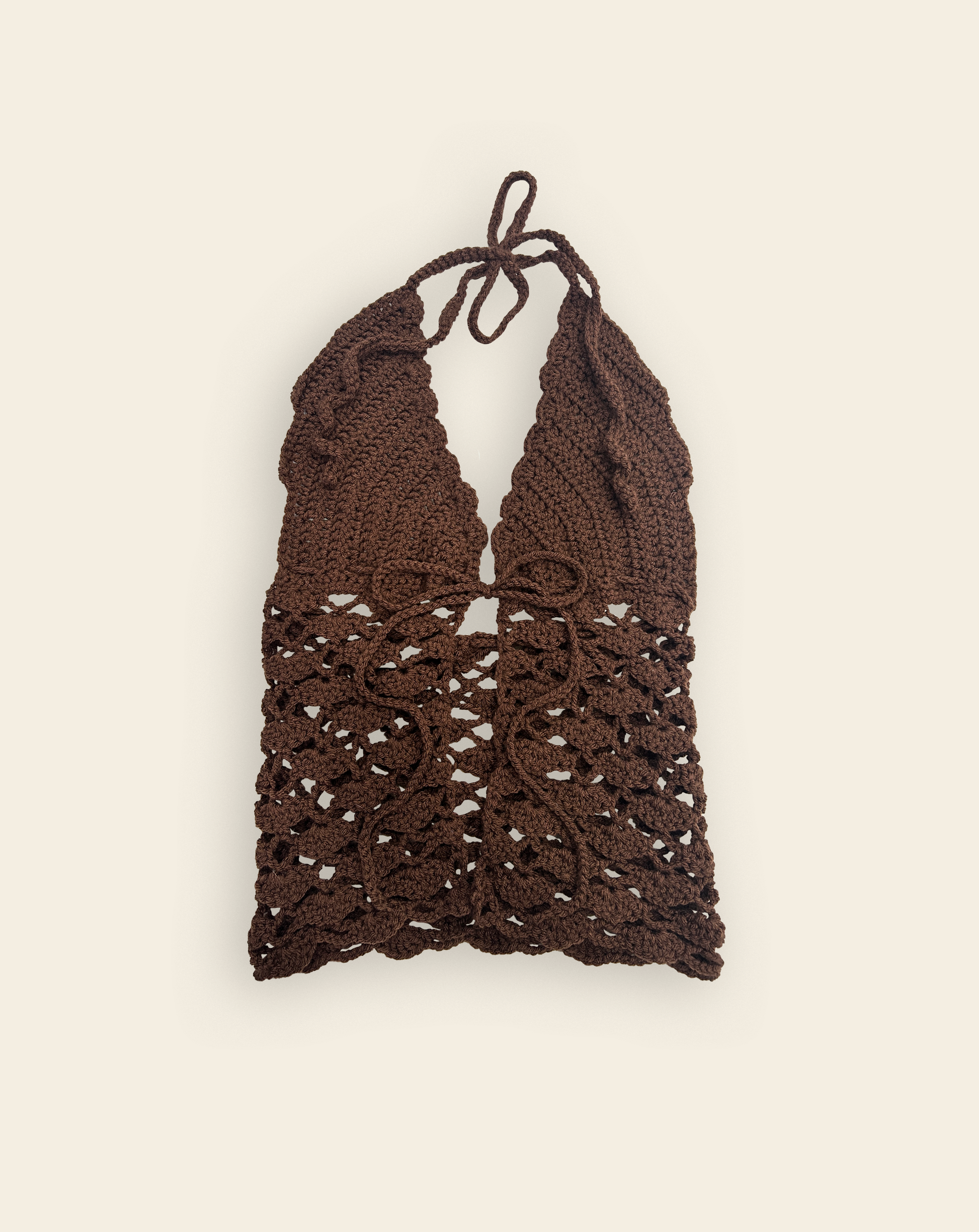 Brown crochet halter top on a beige background